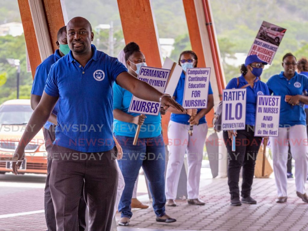 President of the TT Registered Nurses Association Idi Stuart, left, leads protesting nurses outside the Scarborough General Hospital in June.  - 