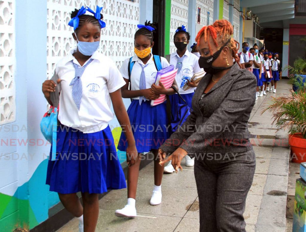 In this file photo Nelson Street Girls RC Primary School principal Lisa Lynch points to where a student should stand to ensure physical distancing when classes resumed for Standard 5 students on July 20. Photo: Ayanna Kinsale
