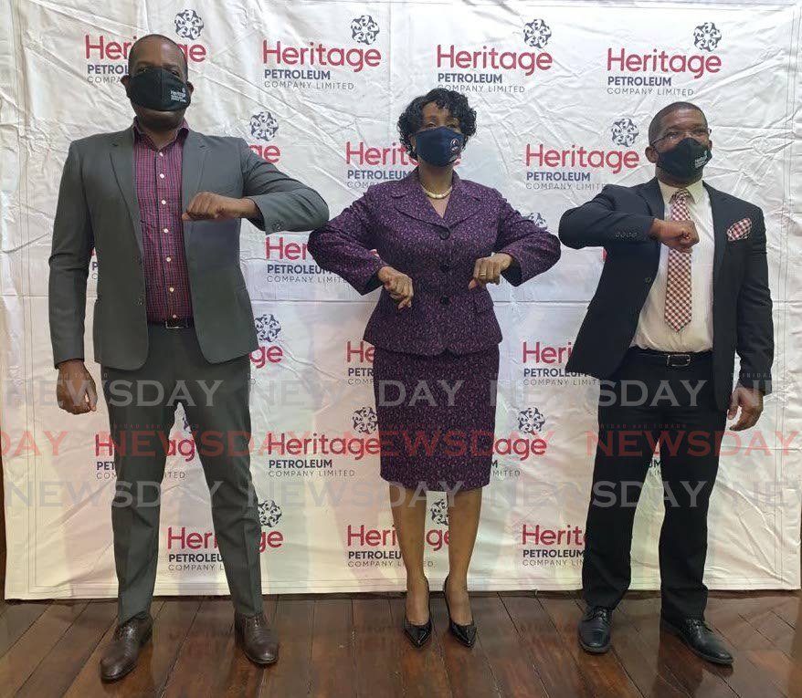 Minister Lovell Francis, Major Ret. Cheryl Richardson and Heritage CFO Nigel Campbell after the computer donation.  PHOTO COURTESY HERITAGE PETROLEUM - 