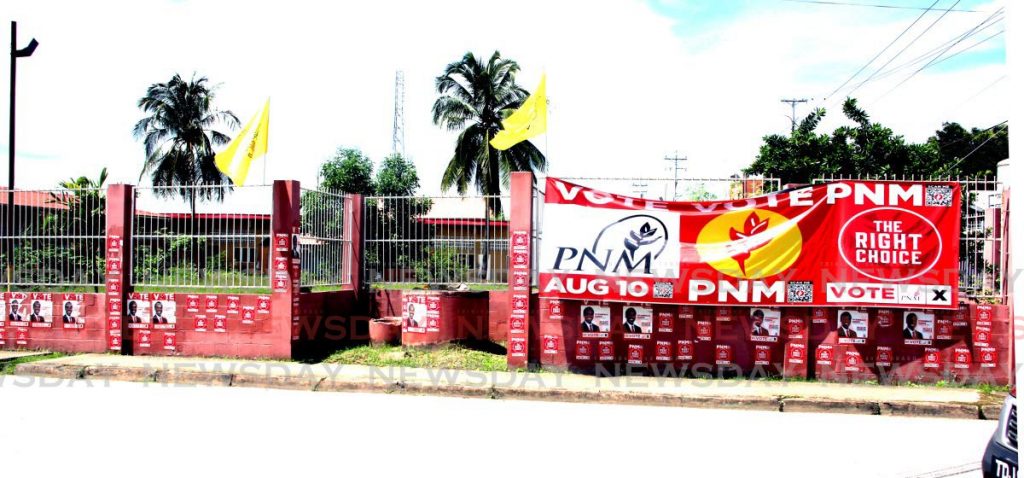 A few UNC flags flutter above PNM banners of Laventille West candidate Fitzgerald Hinds in Beetham Gardens. - 