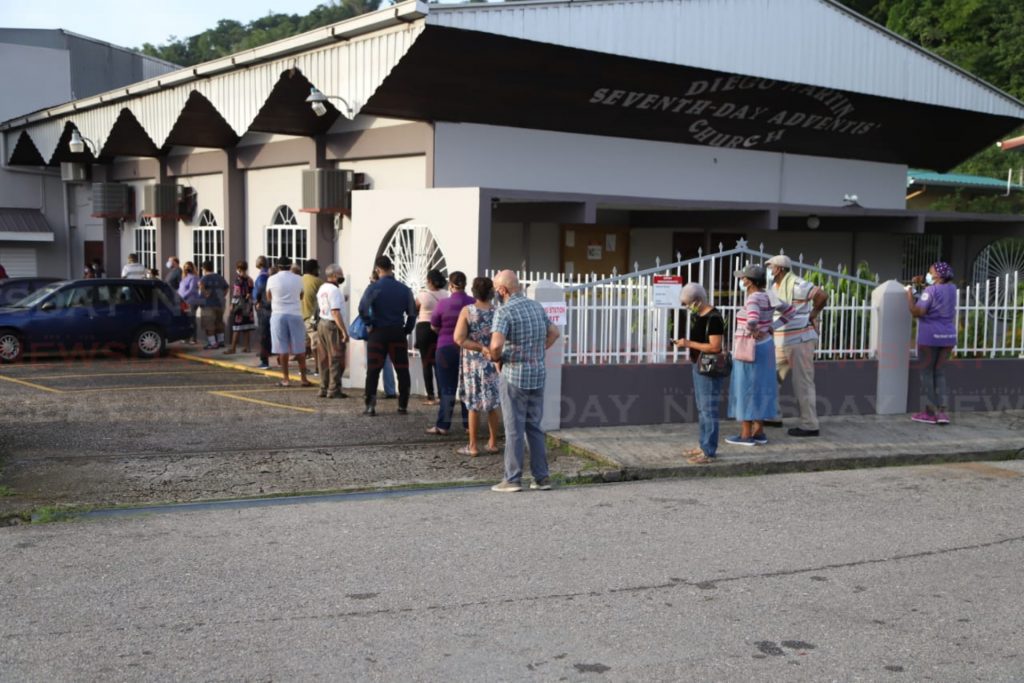 Voters line up at a polling station in Diego Martin. - Jeff Mayers