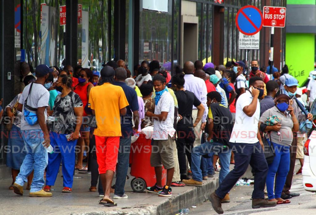 FILE PHOTO: A crowd, not physically distanced and some not properly wearing masks, waiting outside Royal Bank on Independence Square on September 1. - ROGER JACOB