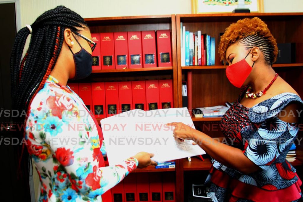 Education Minister Dr Nyan Gadsby-Dolly discusses plans for the school term with Terisa Lewis-Coutou, support staff member, at the Education Ministry, Port of Spain on Tuesday. - ROGER JACOB