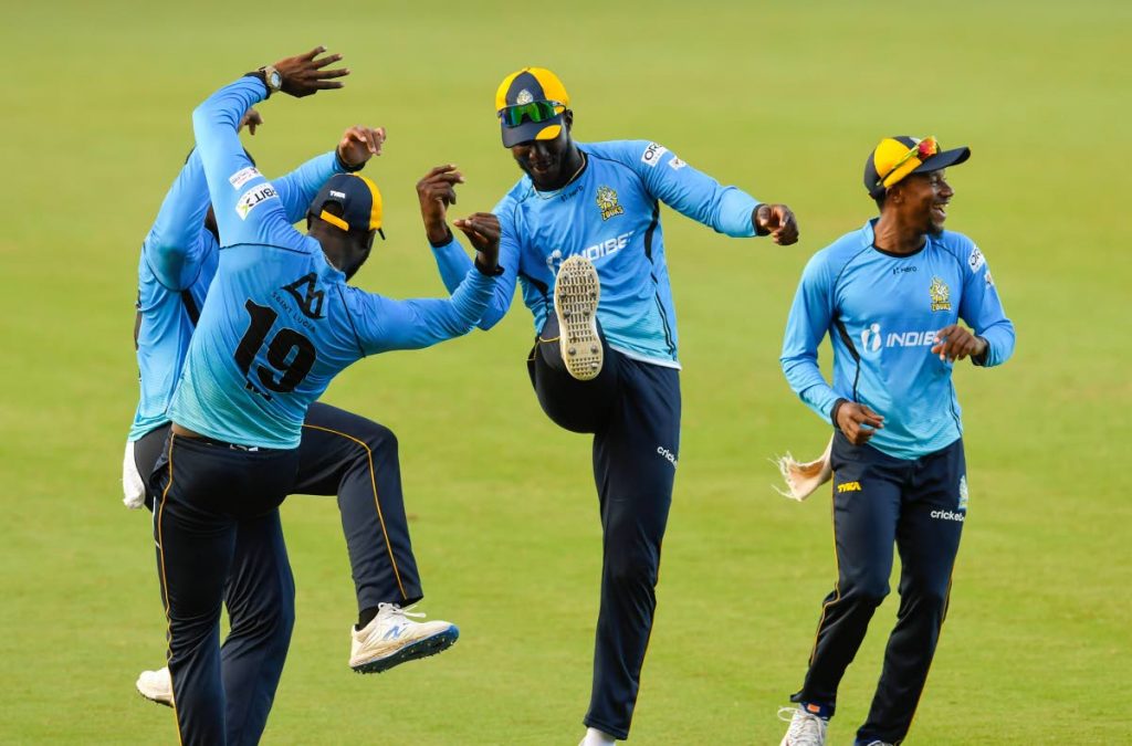 Darren Sammy (second from right), Kesrick Williams (second from left) and Kavem Hodge (right) of St Lucia Zouks celebrate the dismissal of Andre Russell of Jamaica Tallawahs during the teams' Hero Caribbean Premier League match 30 at the Brian Lara Cricket Academy on Sunday in Tarouba. (Photo by CPL T20 via Getty Images) - 