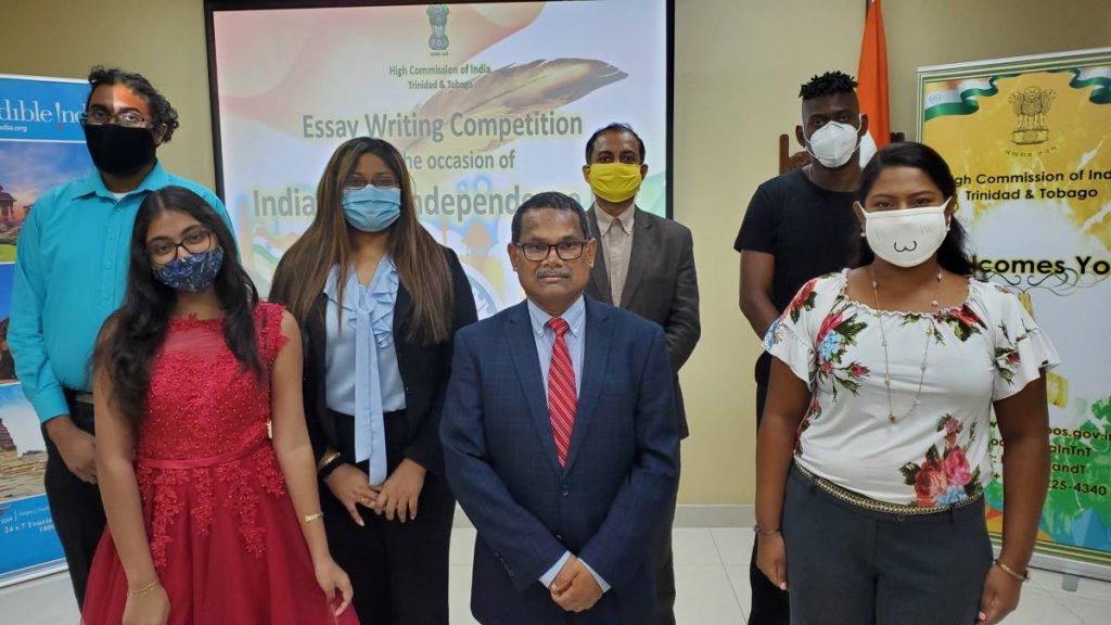 High Commissioner of India  Arun Kumar Sahu, centre, with winners of the India Independence essay competition. 
Left back: Darryl Gransam, second prize; Anisha Dayaram, third place; Aniruddha Das, second place; the secretary at consular, press projects; and Malcolm Superville, third place.
Front left: Aliya Mohepat, second place; and Saraswatie Sankar, first place. The theme of the competition was India’s Achievements after Independence in 1947. - 