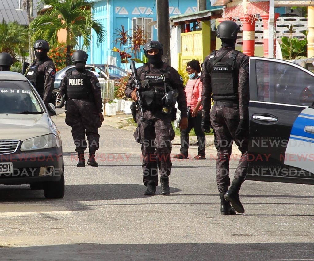 SORT officers accompanied members of the Financial Investigation Bureau to search a house in La Horquetta where $22 million was found in a so-called sou sou scheme last Wednesday. PHOTO BY ROGER JACOB - 