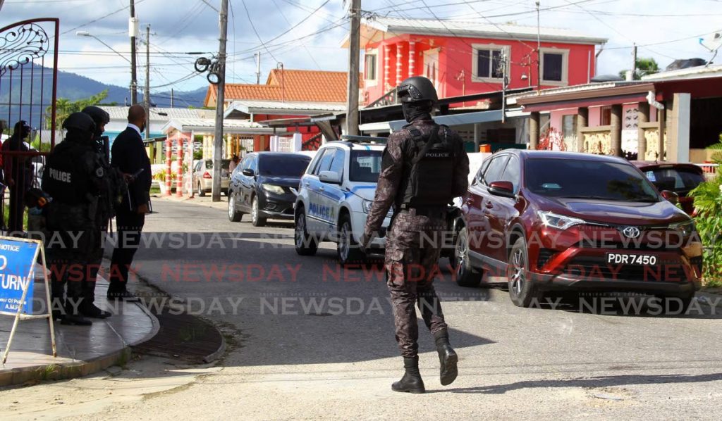 RETURNED: Police returned to the scene in La Horquetta on Wednesday, a day after a raid led to the discovery of $22m in a house believed to be the proceeds of sou-sou scheme. The money has since been returned.  - ROGER JACOB