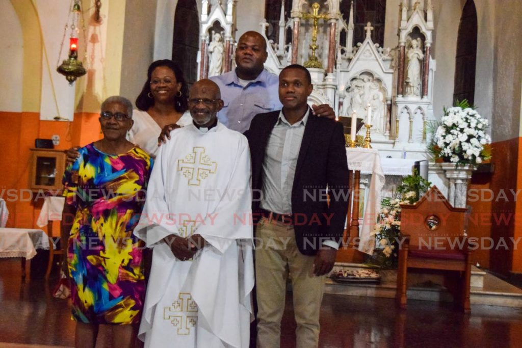 Fr Paul Bousignac is flanked by his sister Alexandrine Hicks (left front), daughter Christa, and sons Christian and Pierre after being ordained at the St Joseph RC Church, St Jospeh on Thursday. - Vidya Thurab