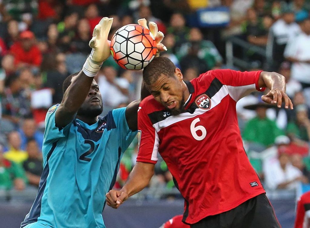 In this July 8, 2015 file photo, TT’s Jan-Michael Williams  makes a save off of the head of team-mate Radanfal Abu Bakr against Guatemala during a match in the 2015 CONCACAF Gold Cup at Soldier Field, Chicago, Illinois. Both players shared their memories of former football coach Nigel Grosvenor, who died on Friday. - (AFP PHOTO)