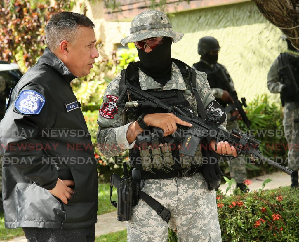 FILE PHOTO: Commissioner of Police Gary Griffith, left,  briefs a special operations officer at the scene of a major drug bust at a townhouse on Regents Drive, West Moorings, on December 4, 2018. - 