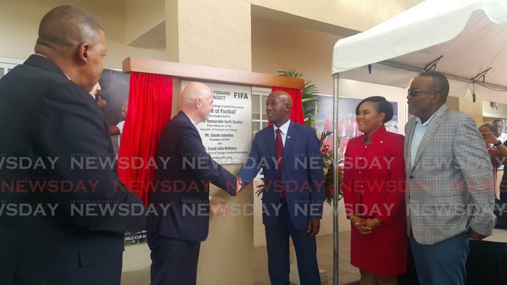 FIFA president Gianni Infantino (second from left) shakes hands with PM Dr Keith Rowley during the opening of the Home of Football on November 18, 2019. Photo by Narissa Fraser - 