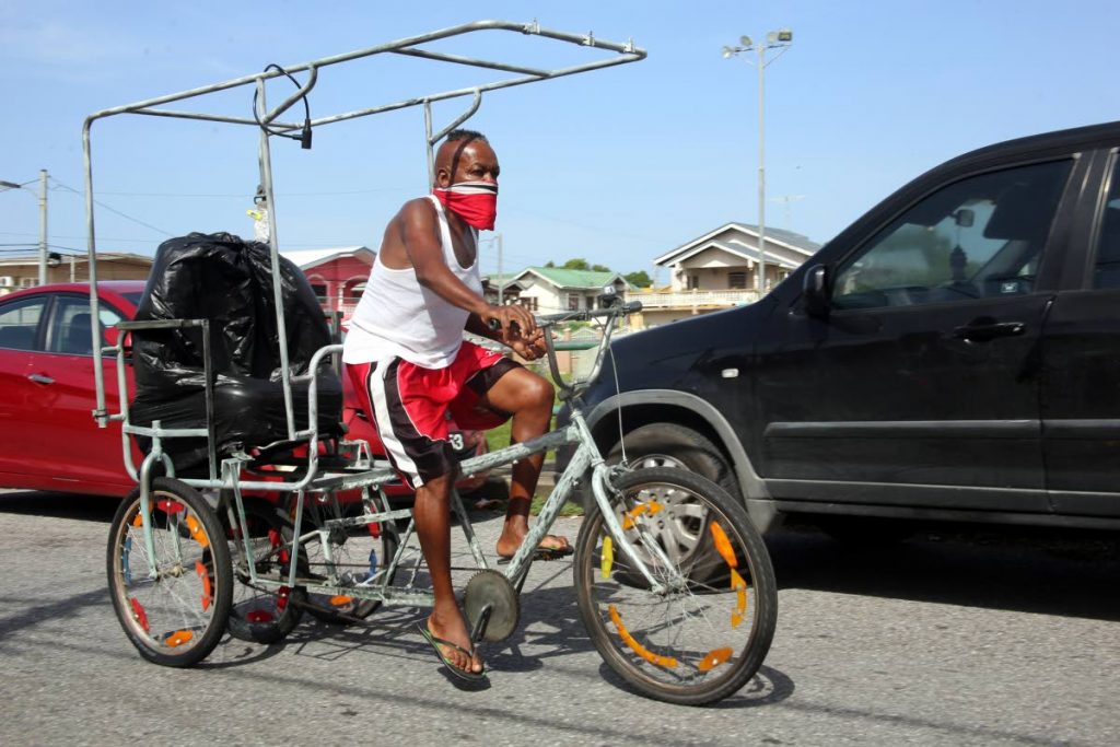 A man rides a carriage bike along Don Miguel Road in San Juan. 
PHOTO BY SUREASH CHOLAI - 