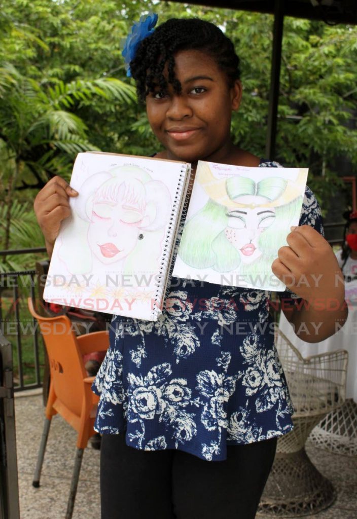 Symmya Hyde holds two of her anime drawings at her home in Brazil. She learned the Japanese art on YouTube.  PHOTOS BY ANGELO MARCELLE
 - 