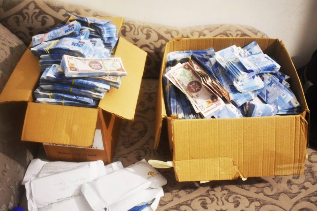 Two cardboard boxes filled with cash seized by police at a building in La Horquetta on September 22. Four soldiers are in custody for questioning about the removal of an envelope of cash from the scene when $22 million was seized.
 - 