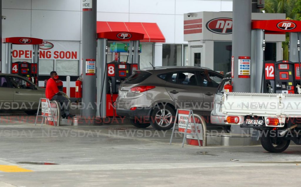 Drivers full up on gas at the NP station on O'Meara Road, Piarco on Monday. Government plans to sell the gas stations of the state-owned company. PHOTO BY ROGER JACOB - 