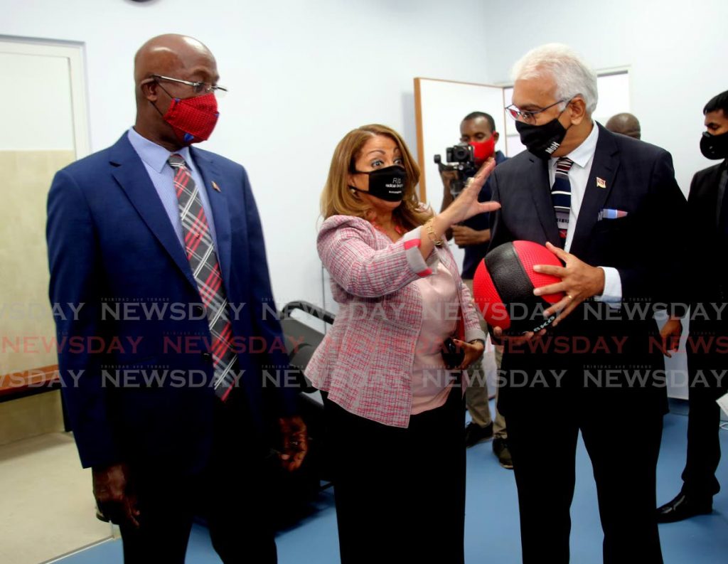 HEALTHY DISCUSSION: North West Regional Health Authority chairman Lisa Agard speaks to Health Minister Terrence Deyalsingh while PM Dr Rowley listens on Tuesday at the opening of the Diego Martin Health Centre.  - SUREASH CHOLAI