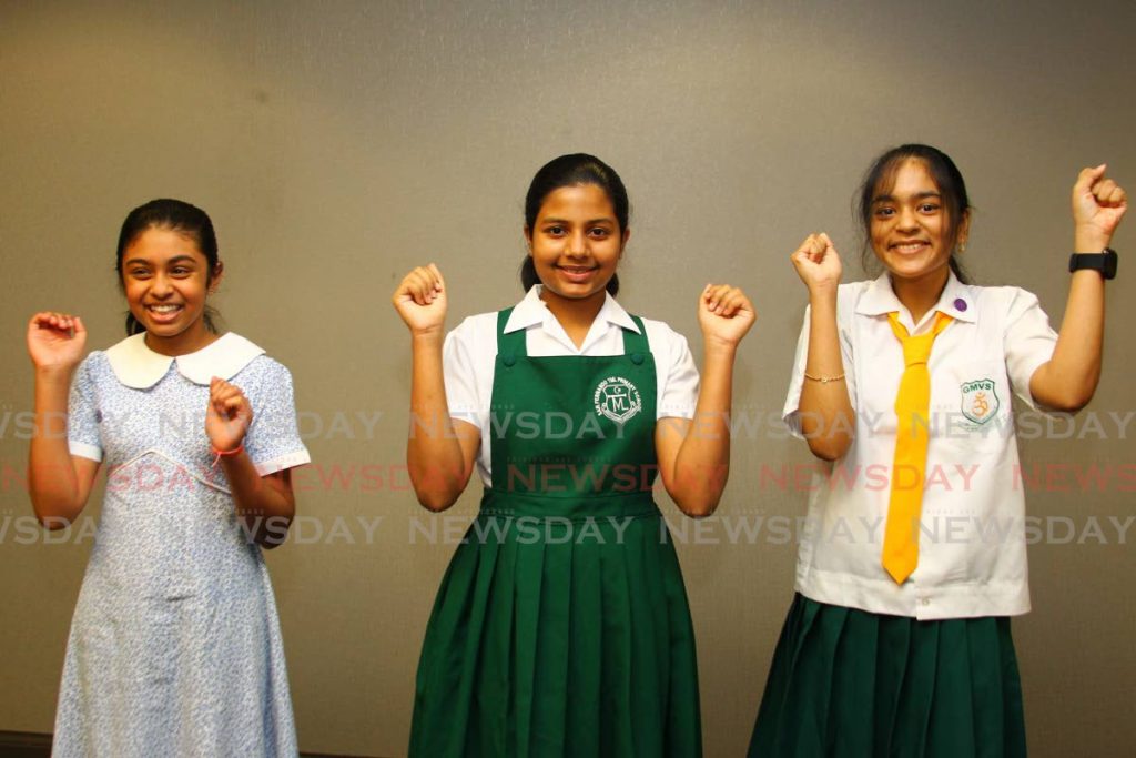 SEA’S TOP THREE: Ameerah Beekhoo, centre, who placed first nationally in the 2020 SEA exams is flanked by second placed student Anjaana Dan, left, and third placed student Sushmita Ramsawak on Thursday at the Education Ministry in Port of Spain.   - ROGER JACOB
