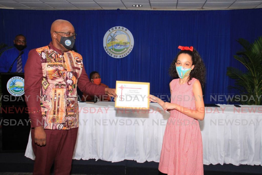 Tobago's top SEA student Susannah Thompson receives an award token from Education, Innovation and Energy Secretary Kelvin Charles during the SEA results presentation ceremony at  Victor E Bruce Financial Complex, Scarborough. Thompson passed for Bishop's High School. PHOTO BY AYANNA KINSALE - 