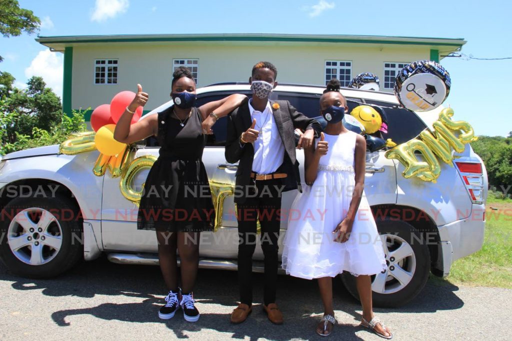 GRADUATING COUSINS: Cousins, from left, Khelsey Alfred, Deandre Baptiste and Allyanne Thomas all decked out for their graduation. PHOTO BY AYANNA KINSALE 