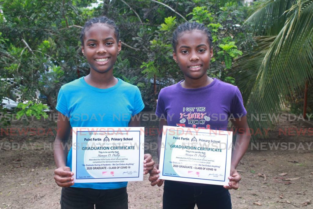 Shamaya Phillip and Shinaya Phillip displays their graduation certificate after completing SEA exams during the Covid19 pandemic. - CHEQUANA WHEELER
