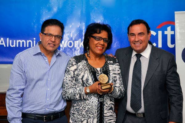 In this 2013 file photo, Joy Caesar receives the Citi Distinguished Alumni award from Suresh Maharaj, Central America & Caribbean Cluster Head, left, and Dennis Evans, Citi Country Officer & Caribbean Cluster Head. Caesar, a banker and musical director of the Southernaires choir, died on Saturday. Photo: Citigroup.com  - 