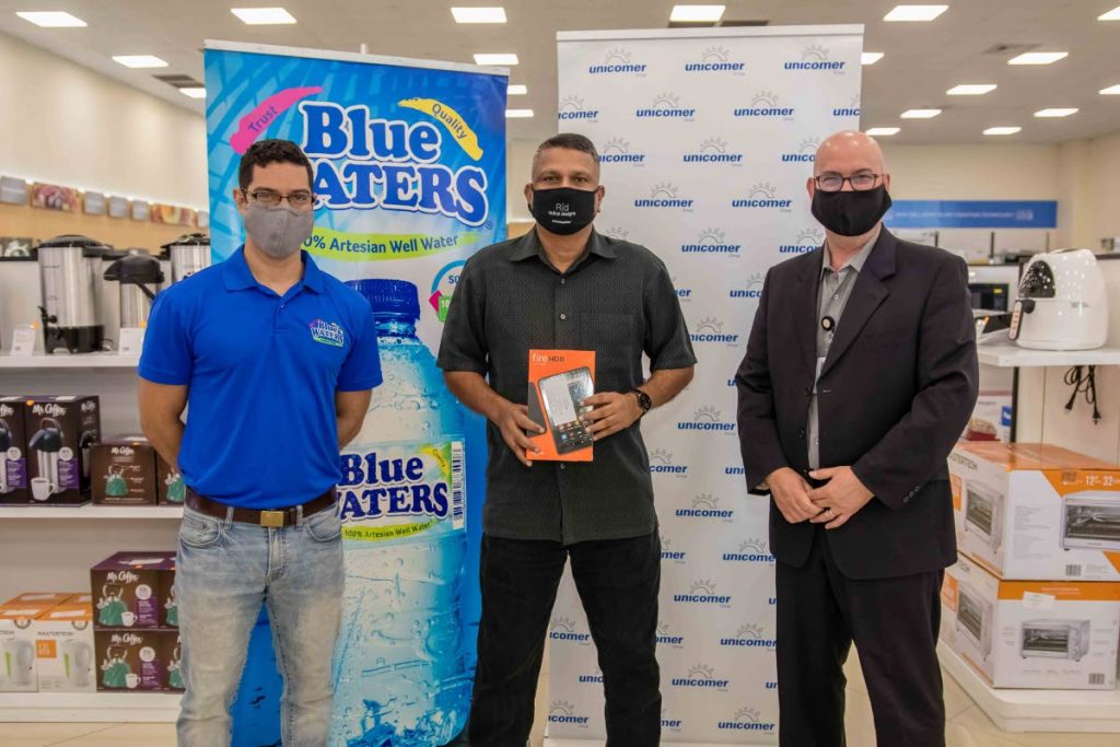 Nicholas Bengochea, band manager, Blue Waters); left, Clive Fletcher, managing director, Unicomer Trinidad Ltd and Raymond Surujbally, principal, Macaulay Government Primary School. - 