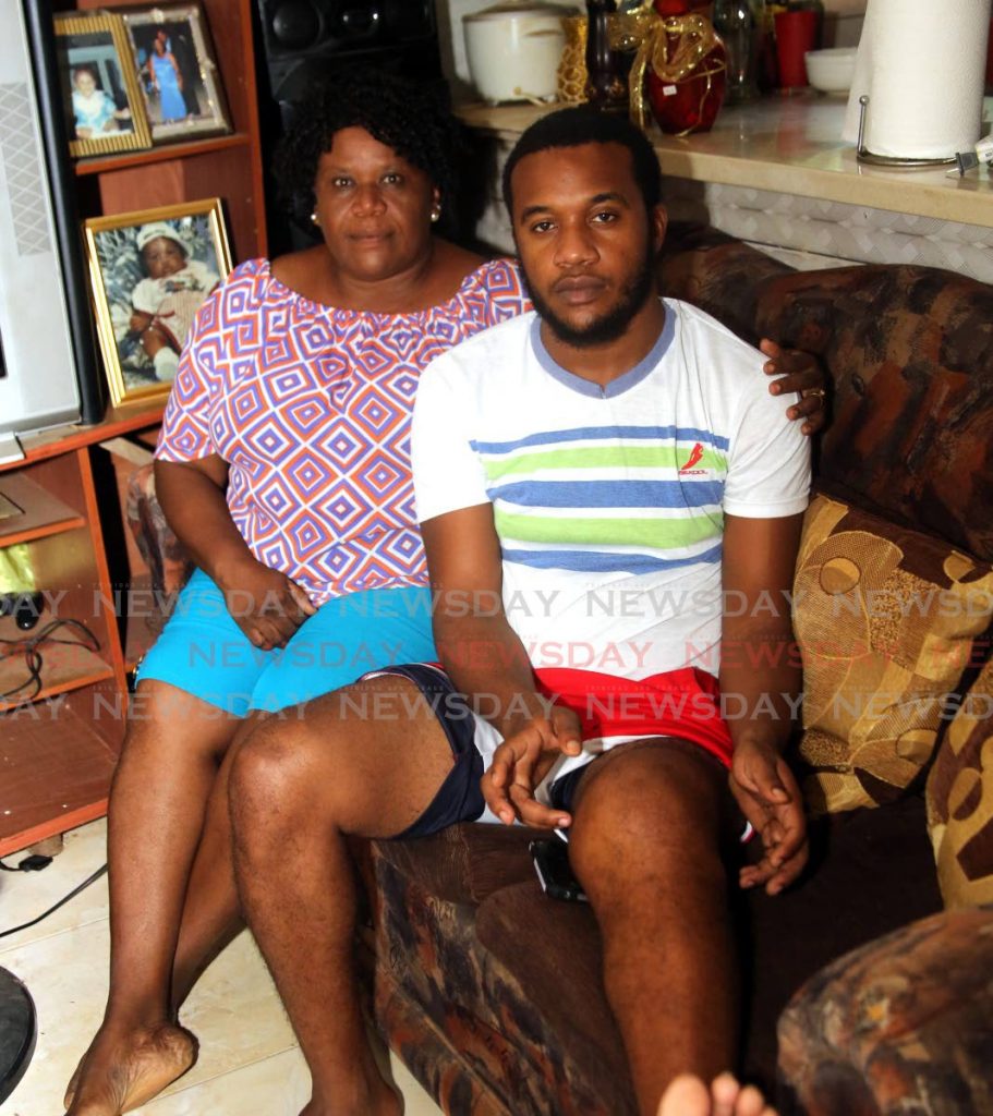 Stephon Samuel is supported by his mother Dianne Constantine-Hall at their La Belle Vue, Paramin home on Monday as they appeal to the public for help to raise money for knee-replacement surgery for Samuel.  - SUREASH CHOLAI