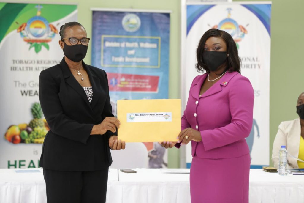 New TRHA board deputy chairman Beverly Nola Adams, left, receives her instrument of appointment from Health Secretary Tracy Davidson-Celestine on Monday. PHOTO COURTESY DIVISION OF HEALTH - 