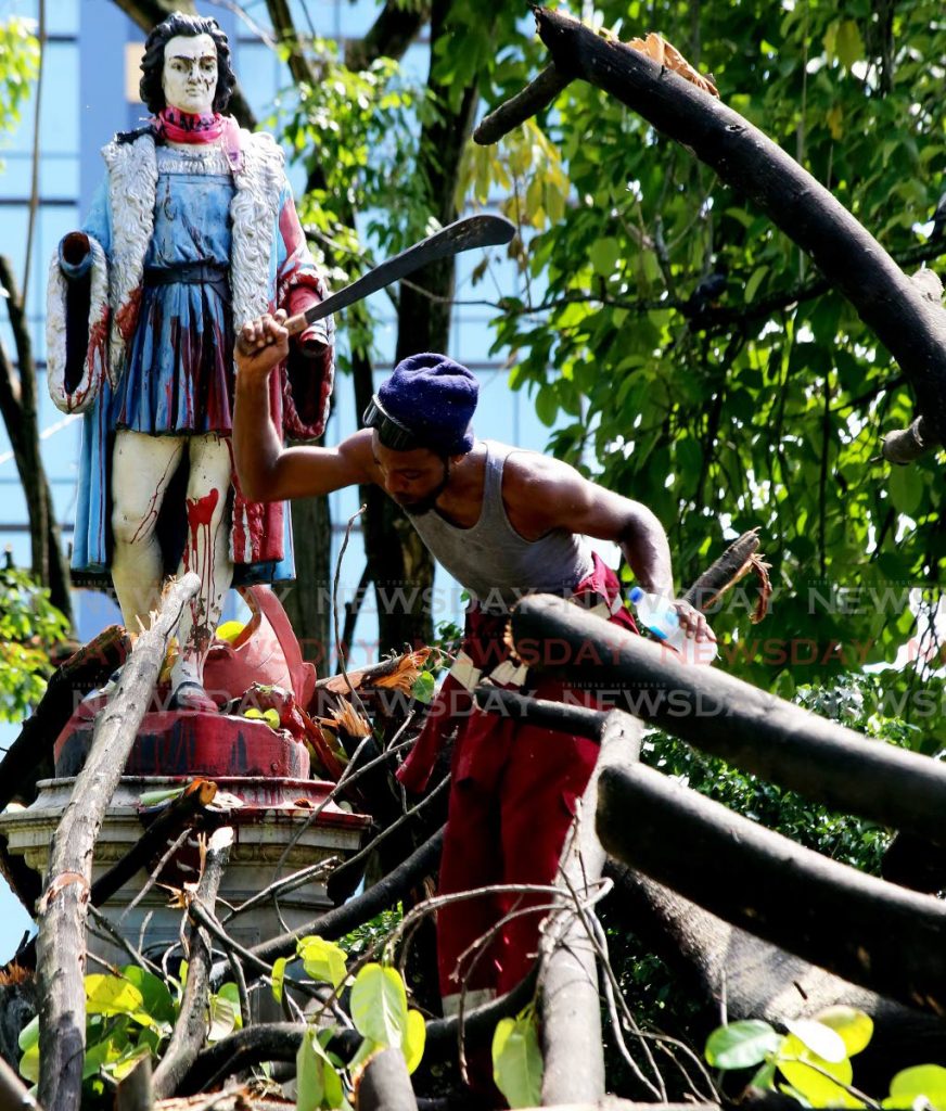 HANDS OFF COLUMBUS:  The hands of the Christopher Columbus statue were conspicuously missing as PoS City Corporation workmen visited on Tuesday to start removing a massive tree which fell in the square last week during bad weather. No one knows if the falling tree was behind the damage to the  statue. PHOTO BY SUREASH CHOLAI - SUREASH CHOLAI