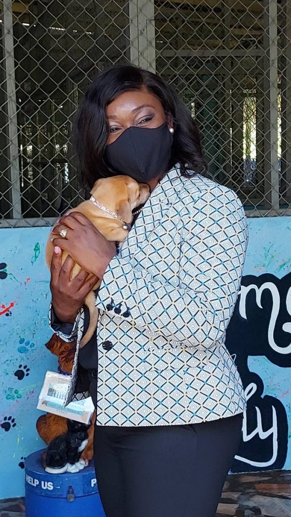 Health Secretary Tracy Davidson-Celestine hugs a puppy at the Tobago Society for the Prevention of Cruelty to Animals in Scarborough on Friday. - 