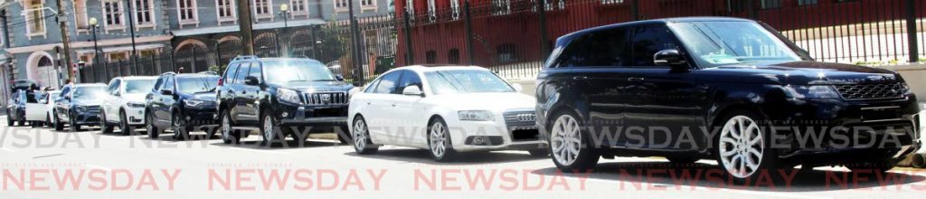 EASY STREET: A row of luxury sedans and SUVs belonging to parliamentarians are parked 
outside the Red House last week while MPs were debating the budget in the House of Representatives.
PHOTO BY SUREASH CHOLAI - SUREASH CHOLAI