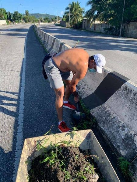 Michael Phillips cleans the side of the road along the Diego Martin Highway in an effort to continue the Keep Moving Family and Fitness Sundays. - 