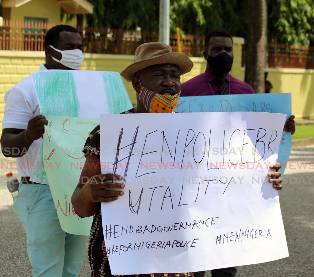 Nigerian Oluwaseun Olubode outfront with his countrymen Tope James (left) and Adebowale Opadeyi ( right) protesting their country's Special Anti-Robbery Squad (SARS) outside the Nigerian embassy on Maxwell Phillip in St Clair - SUREASH CHOLAI