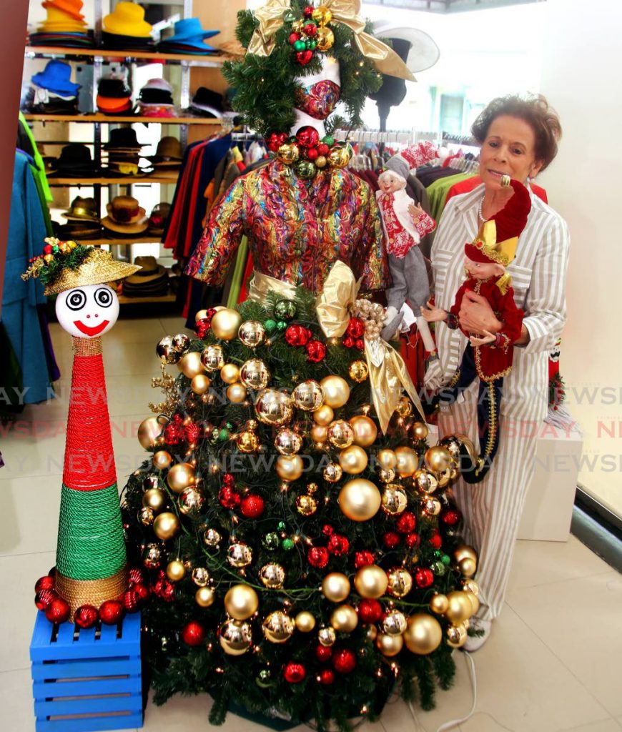 Hannah Janoura stand with this mannequin she has converted to a Christmas tree that has been attracting many onlookers at her business place , Janouras Custom Design Ltd on Sackville Street in Port of Spain. - SUREASH CHOLAI