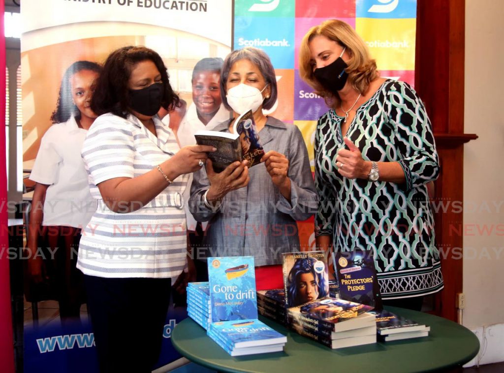 Education Ministry curriculum director Anna Singh, from left,  Bocas Lit Fest founder and festival director Marina Salandy-Brown and Roxane De Freitas, chairperson, Scotiabank Foundation, review some of the 325 young adult books donated for secondary school students at the Writers Centre, Alcazar Street, St Clair on Friday. PHOTO BY SUREASH CHOLAI - 