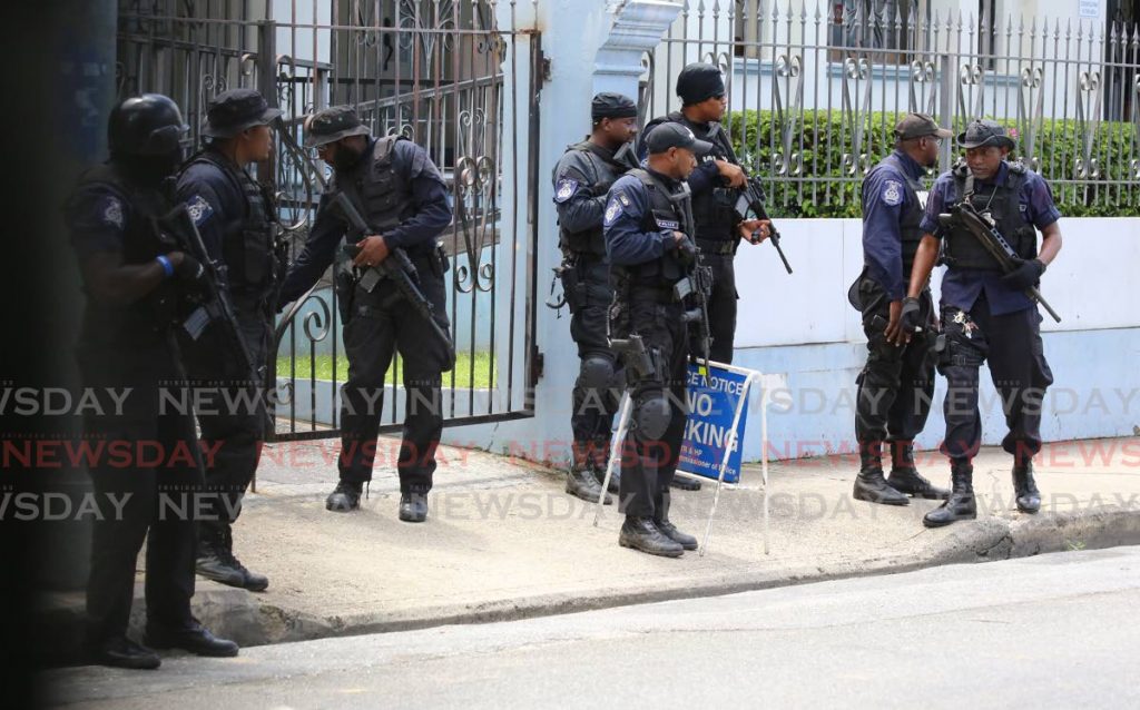 File photo: Police stationed outside the Port of Spain Magistrates Court as three suspected gang members from Beetham Gardens, appeared on gang charges. - SUREASH CHOLAI