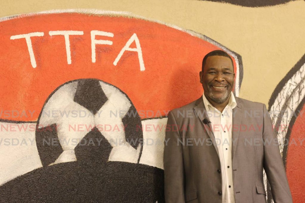 In this November 24, 2019 file photo, William Wallace stands next to the TTFA logo, at the Home of Football in Couva, after winning the TTFA elections. - Marvin Hamilton