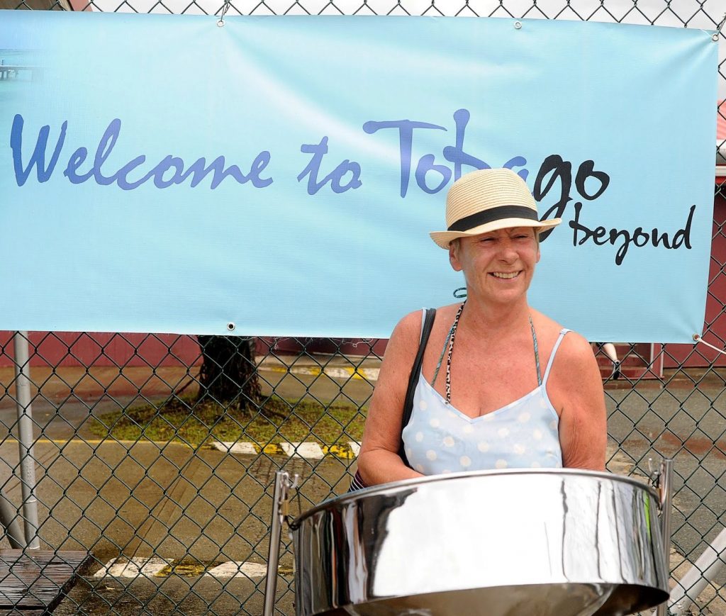 A visitor tries her hand at the steelpan upon arrival to Tobago on Monday. 