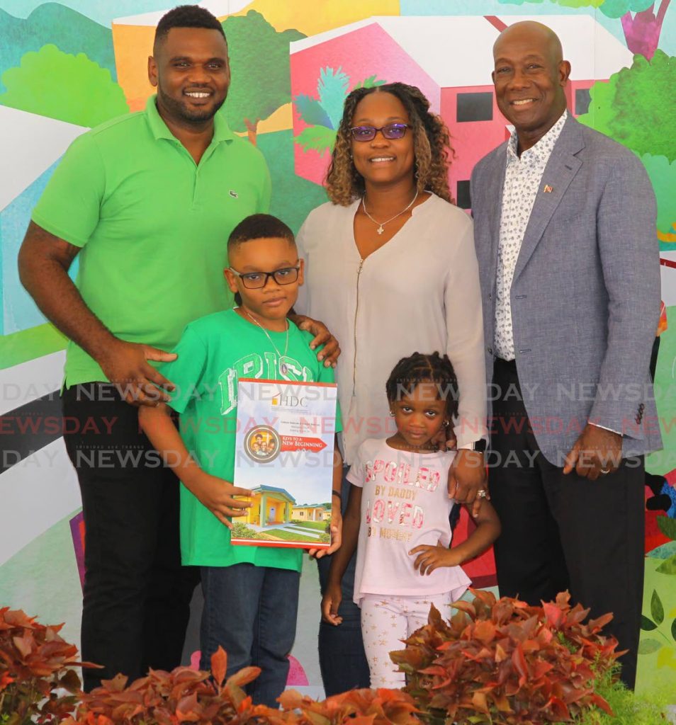 In this February 12, 2020 file photo, Prime Minister Dr Keith Rowley was on hand to present Daniel Duncan, his wife Coleen, and their children Noah and Shilba, keys to their new home at Mahogany Court, Mt Hope. Housing construction is expected to be a highlight of the 2020/2021 budget. PHOTO BY ROGER JACOB. 
 - 