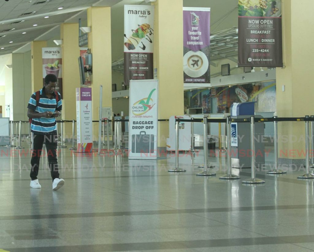 In this March 23 file photo, a man walks through an empty check-in section at Piarco International Airport. The borders were closed on March 21. The Prime Minister on Saturday said he is in talks with the Guyana government on resuming travel with TT. PHOTO BY AYANNA KINSALE - 