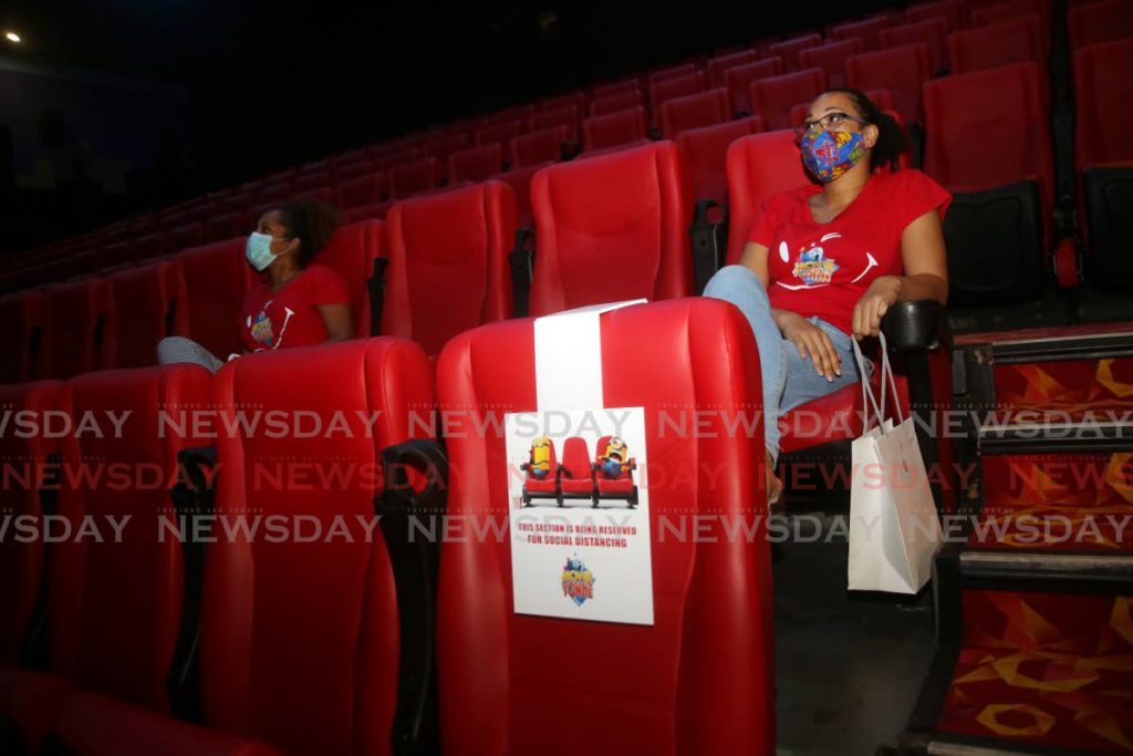 In this June 24 file photo, two people sit two seats apart at MovieTowne, Mucurapo when cinemas had a short-lived reopening. Cinemas will reopen once again under similar physical distancing protocols, the Prime Minister said on Saturday. PHOTO BY SUREASH CHOLAI - 