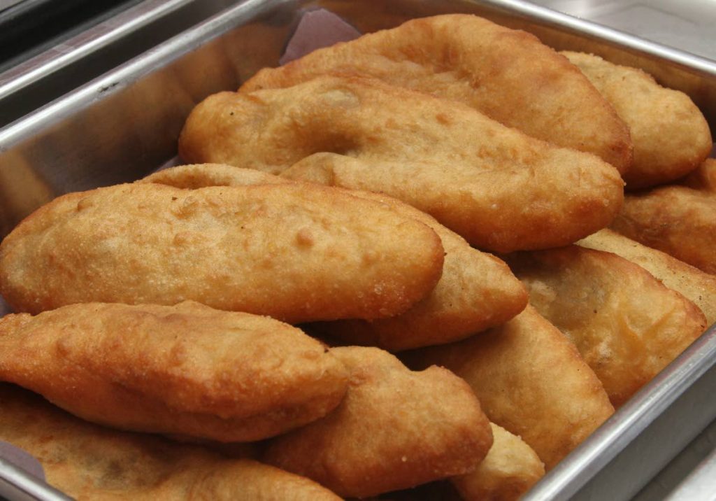 Golden brown Aloo Pies from Hosein's Roti Shop. - Angelo Marcelle