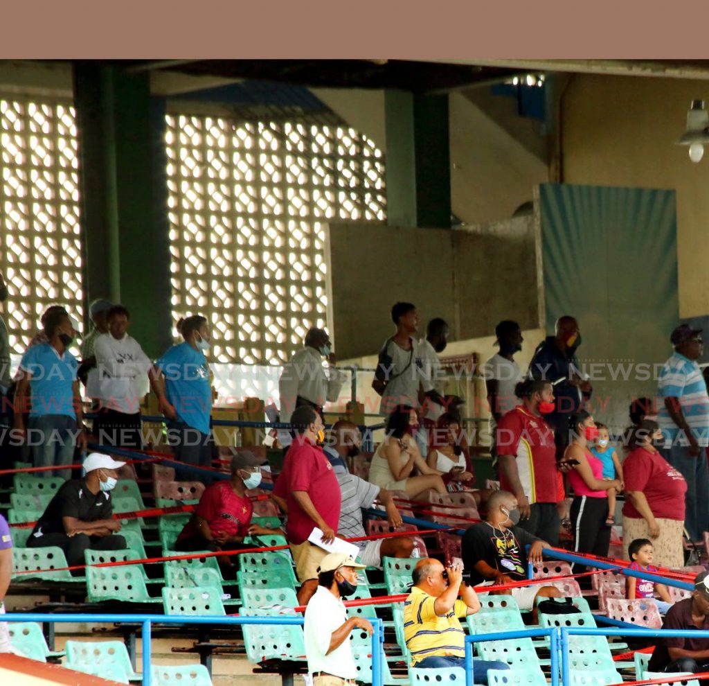 Horseracing fans look at one of the day’s races, at the Santa Rosa Park, Arima, on Saturday. Although fans were not allowed to attend the races, according to the Minister of Health Terrance Deyalsingh , several returned, on Saturday, for the first time since coivd19 safety measures were implemented. - SUREASH CHOLAI