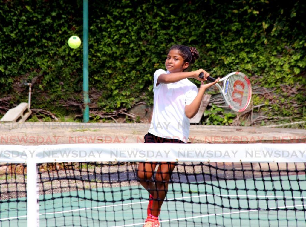 Carissa Mohammed in action in the girls Under-10 singles. Mohammed defeated Kiara-Marie Edwards 6-0 at the Lease Operators Ltd Junior Tennis tourament at Trinidad Country Club, Maraval, on Saturday. 
PHOTO BY SUREASH CHOLAI - 