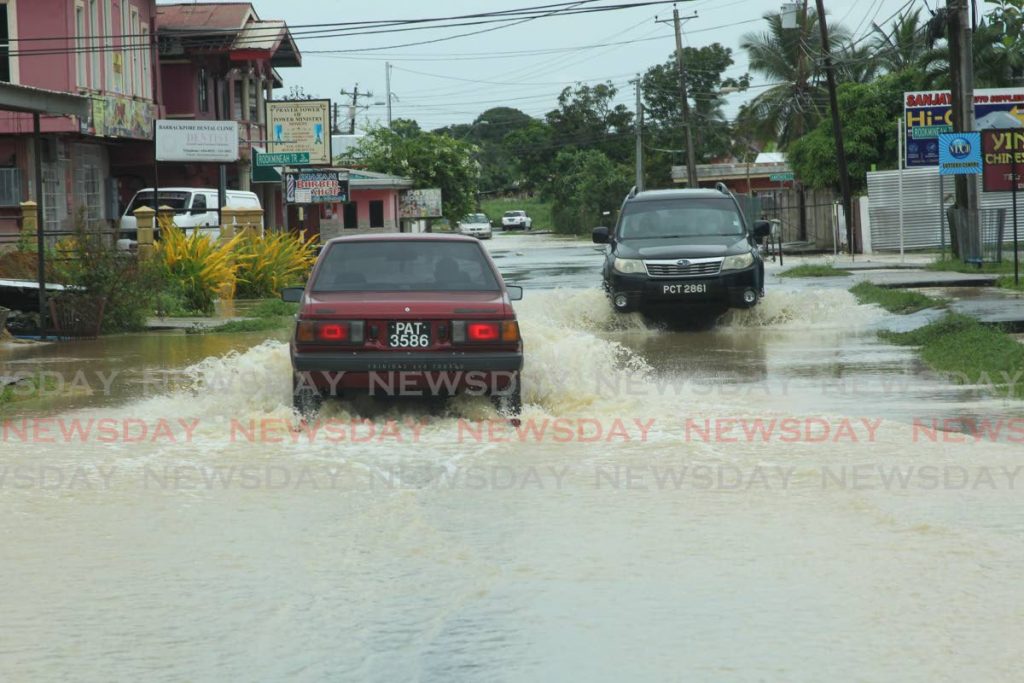 Flooded roadway along Lower Barrackpore  following heavy rainfall. - Lincoln Holder