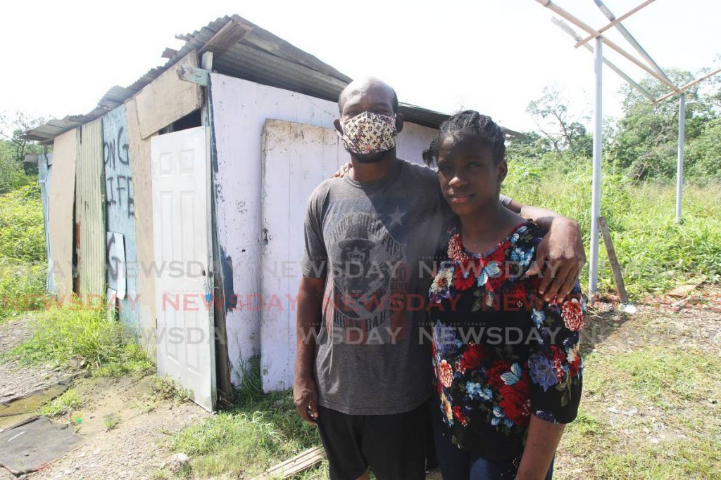 Christopher Wolfe stands with Shirley outside the shack on land owned by the State in Claxton Bay. - Lincoln Holder