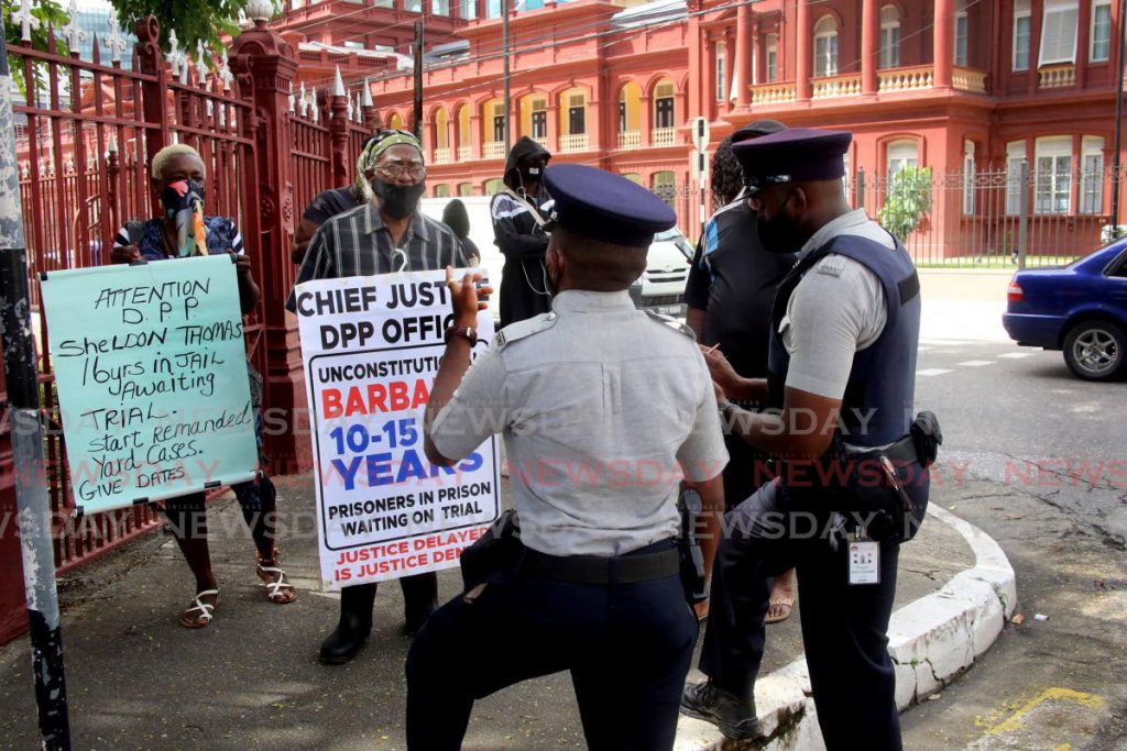 Police question protesters of the prison reform movement outside the Red House in Port of Spain. - SUREASH CHOLAI