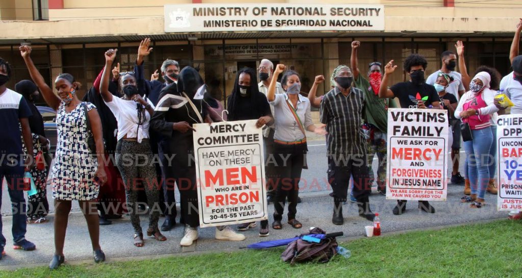 Calling for prison reform, these protesters gather in front the Ministry of National Security and opposite the Hall of Justice in Port of Spain on Friday. - SUREASH CHOLAI