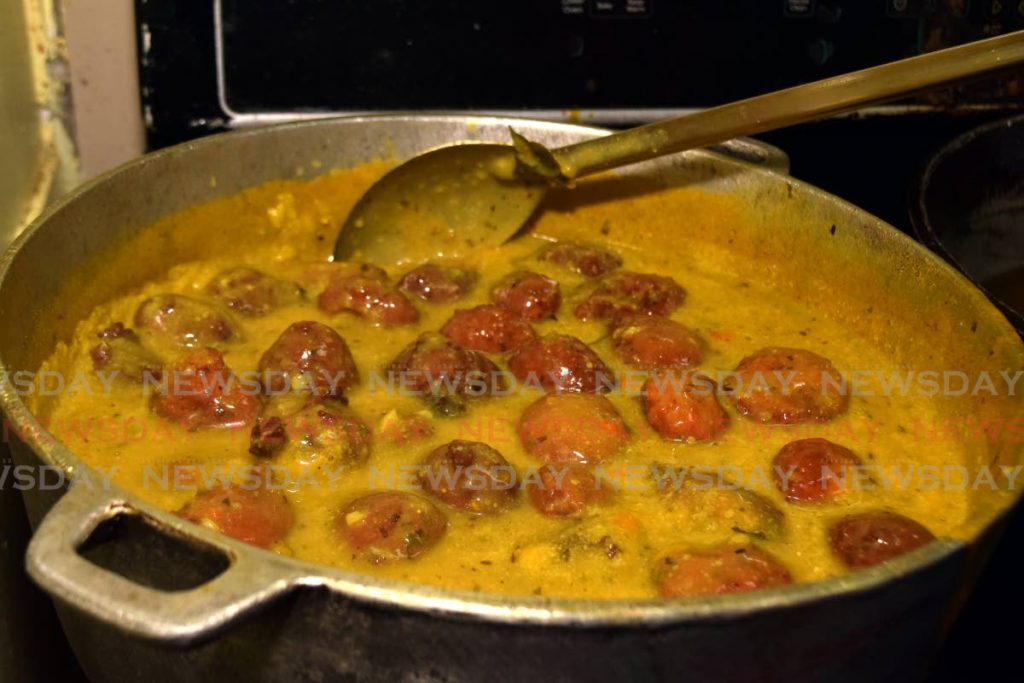 Ann Marie Rambally stirs the pot of kurhi in her kitchen at Annie's Culinary Cuisine Ltd. - Vidya Thurab