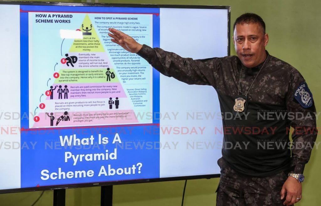 Commissioner of Police Gary Griffith explains how pyramid schemes work during the police weekly media press briefing, Police Administration Building, Port of Spain, on Tuesday. - Jeff Mayers